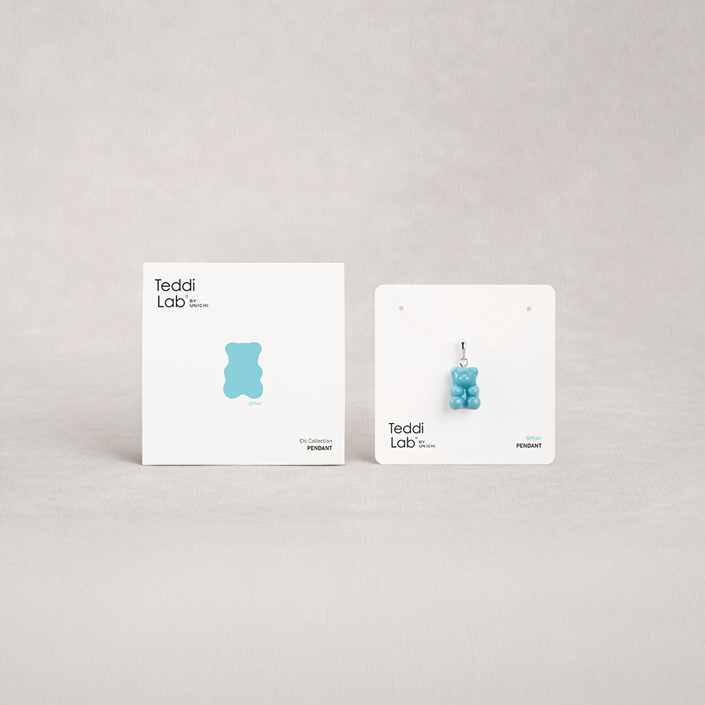 Two blue gummy bear-shaped earrings on display cards with 'Teddi Lab' branding on a light gray background.