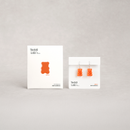 Gummy bear-shaped earrings on display with 'Teddi Lab' packaging on a gray background