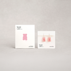 Two boxes of 'Teddi Lab' gummy bear-shaped earrings on a light gray background