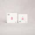 Pink gummy bear-shaped product on a white card with 'Teddi Lab' branding against a light gray background