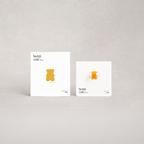 Two white boxes with a yellow bear illustration labeled 'Teddi Lab' on a gray background